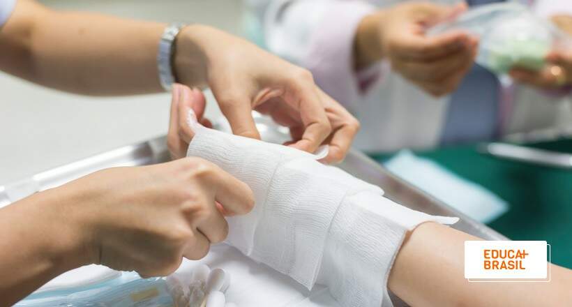 Mão de paciente sendo enfaixada por especialista em Enfermagem em Dermatologia. Mão de paciente sendo enfaixada por especialista em Enfermagem em Dermatologia.