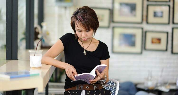 mulher sentada segurando livro mulher sentada segurando livro