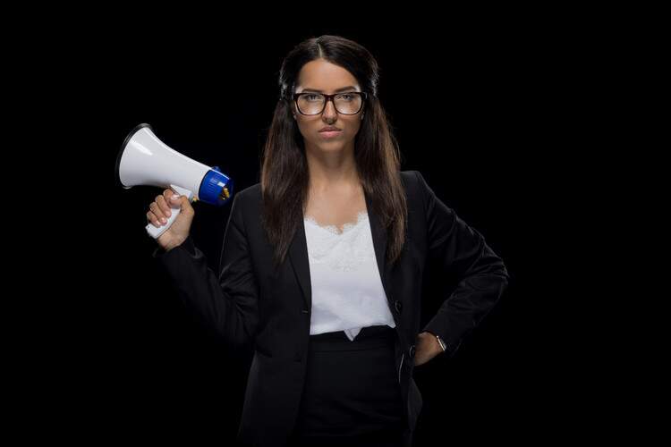 Mulher de óculos segurando um megafone. Mulher de óculos segurando um megafone.